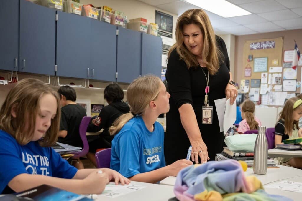 Teacher speaking to student.