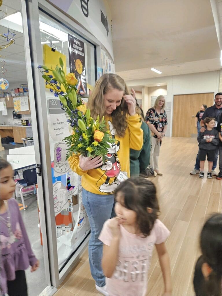 Bobbie Rodriguez with a bouquet of flower.