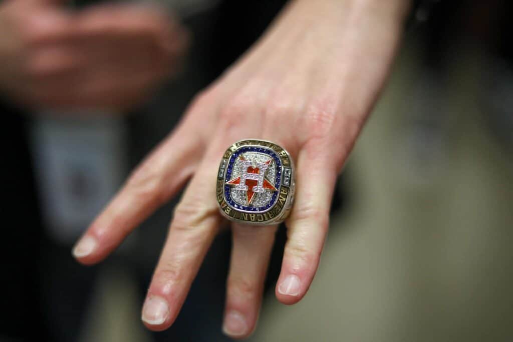 A person poses with the replica World Series ring.