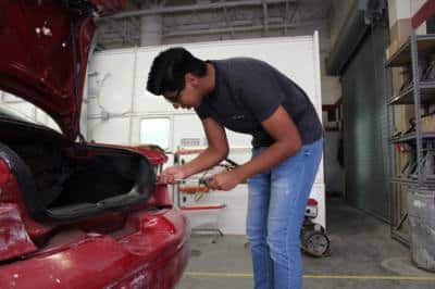 Judson ISD Student working on a car.