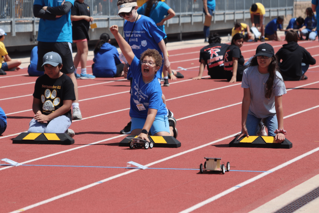 Students cheering on their designs during the race.
