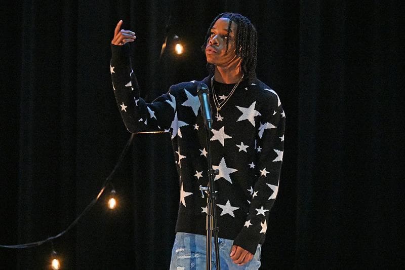 Another student on stage during performing during event.