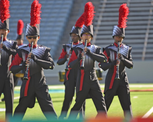 A Cypress- Fairbanks ISD high school marching band displays performance art in the annual Battle at the Berry marching band competition.