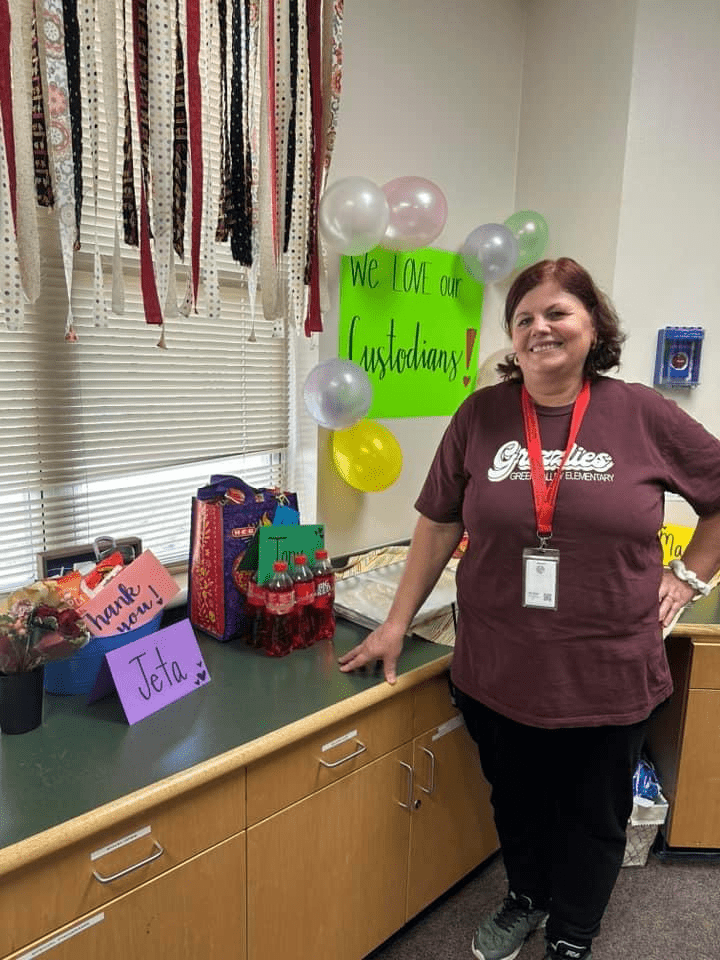 SCUC custodian posing with goodies