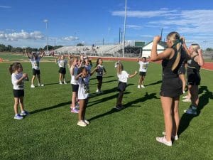 High school cheerleaders teaching school chants